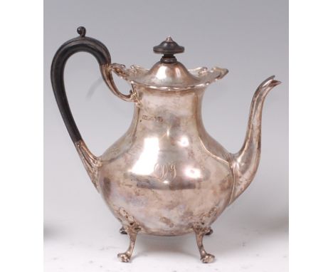 An Edwardian silver teapot, of pear shape, having hinged dome cover, ebony handle, and on scroll feet, 23.6oz, maker M&C, Edi