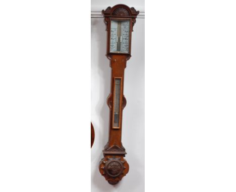 A late Victorian oak stick barometer, having unsigned annotated glass barometer dial with twin adjustable scales, above silve