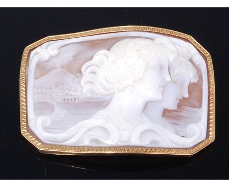 A 19th century carved shell cameo brooch , depicting double profile portrait of maidens within a coastal landscape, all withi