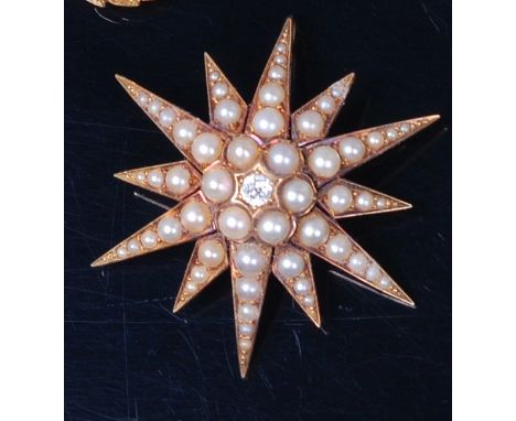 A late Victorian 18ct gold, diamond and seed pearl set star brooch, the centre old brilliant cut diamond weighing 0.15ct, in 