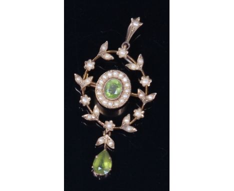 An Edwardian 15ct gold, green peridot and seed pearl set pendant, of oval form, the centre peridot in a surround of small see