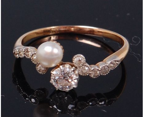 An 18ct gold, diamond and cultured pearl crossover ring, the claw set old brilliant weighing 0.36ct, colour H/I and clarity V