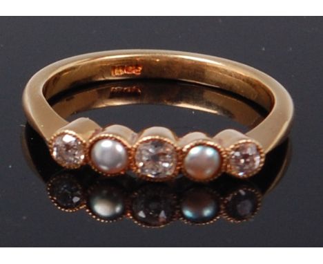 A Victorian 18ct gold, diamond and pearl five stone ring, arranged as three rub-over and milligraine set old brilliants, the 