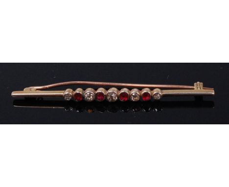 An early 20th century ruby and diamond set bar brooch, arranged as alternating graduated old cut rubies and diamonds, the lar
