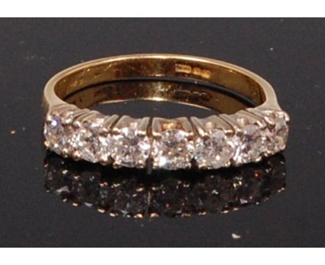 A mid-20th century diamond ring, arranged as seven claw set brilliants in a line setting, total diamond weight approx. 0.7ct,