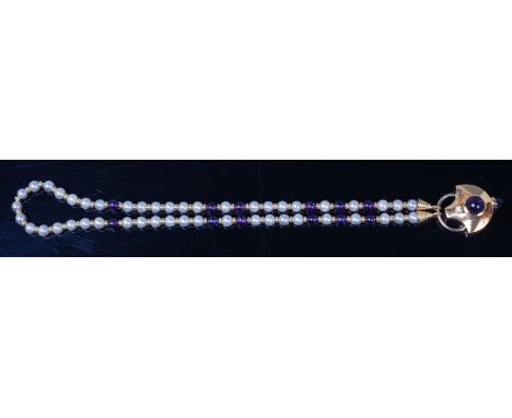 A contemporary 18ct gold, amethyst and diamond set pendant, the small brilliant in a rub-over setting above a cabochon amethy