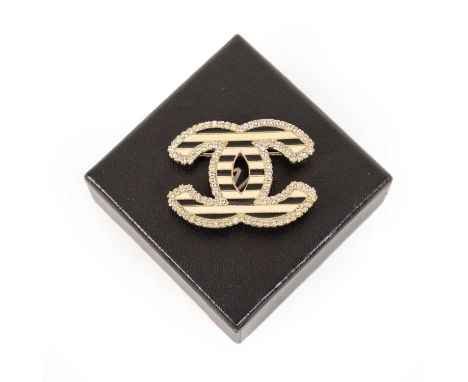 An Enamel and Paste Brooch, by Chanel, two interlocking 'C's' enamelled in black and white within a border of round cut white
