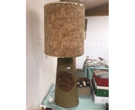 Large 1960's ceramic lamp base in green with central motif, together with the original cork shade, base 66 cm shade 44 cm 