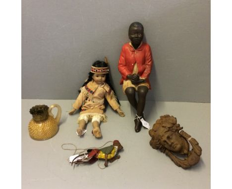 Pottery seated figure of a black boy 45cm, cast iron door knocker, native American doll, tin plated pole climbing monkey (wit