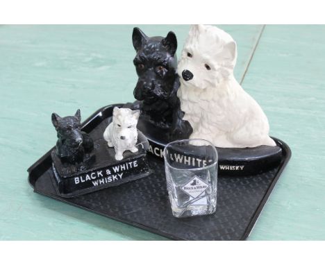 A painted metal black and white whisky 'Buchanan's' advertising figure, a black and white Scotch whisky pottery figure by Bre