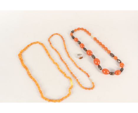 A silver amber set ring plus three amber coloured bead necklaces
