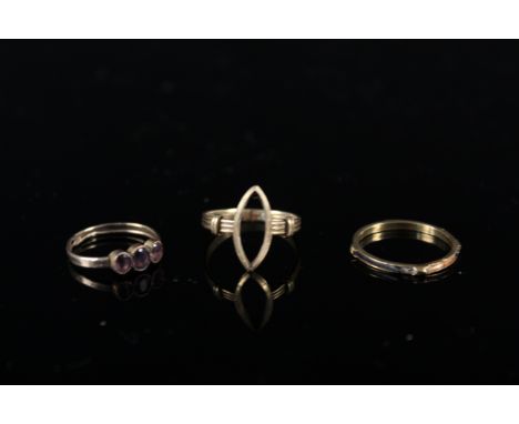 An 18ct gold ring with triple band (stone missing), a 9ct gold three stone ring (as found) plus an unmarked ring (as found), 