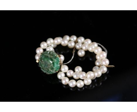 A double strand pearl bracelet with large carved jade clasp mounted in yellow metal (in need of re-stringing)