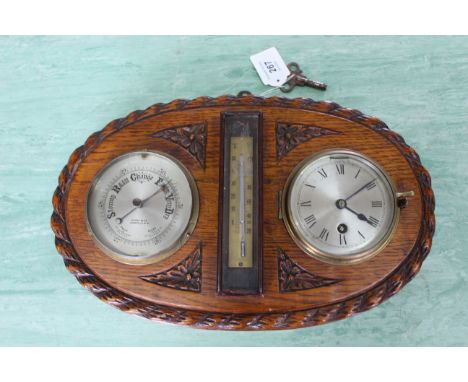 A Victorian oak framed clock barometer, Heath &amp; Co c1890's with thermometer to centre and key
