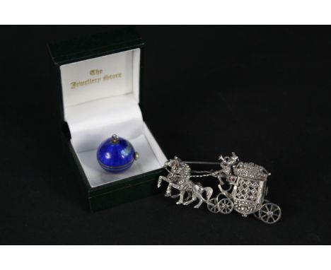 A blue enamelled pendant ball watch (enamel as found) together with a silver brooch in the form of a horse and carriage, the 