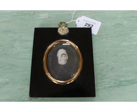 An 18th Century portrait miniature on ivory of a lady wearing a bonnet in ebony frame, frame size 5 1/4" x 4 1/4"