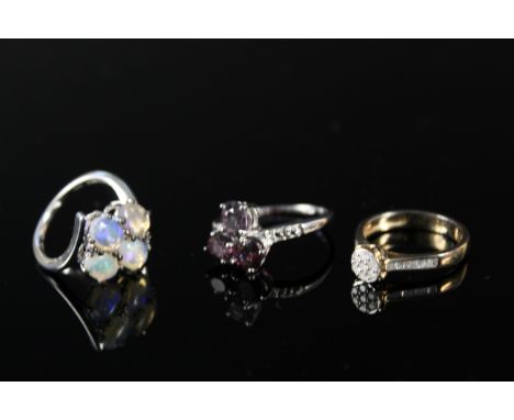 Three silver rings, one set with 0.25cts of diamonds, one opal set and spinel set, all with certificates