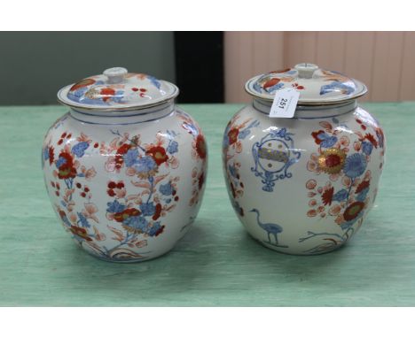 A pair of 20th Century Chinese porcelain armorial ginger jars in Imari palette