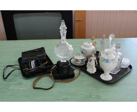 A large cut glass liqueur decanter on faceted foot and pinnacle stopper, two glass decanters, two Wedgwood vases, three china