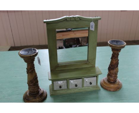 A small wall hanging spice cabinet with mirror back and three ceramic drawers plus a pair of carved wood candlesticks