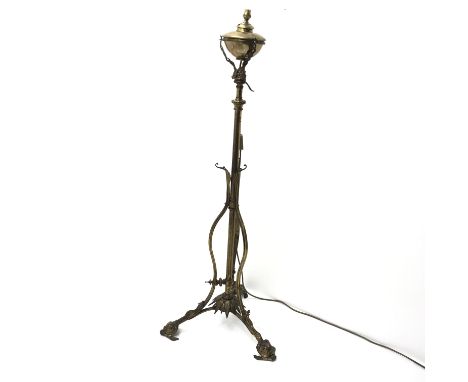 Victorian brass standard lamp, the oil reservoir converted to electric supported by three cast dolphins, telescopic adjustabl
