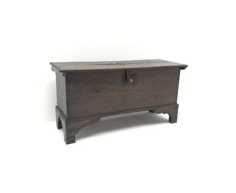Small George lll planked oak coffer, hinged top with chip carved sides and brass nailed initials 'AE', on shaped bracket feet