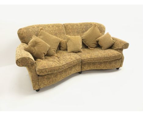 Three seat curved traditional sofa, scrolled arms, upholstered in a gold ground fabric with a floral pattern, W235cm,  Condit