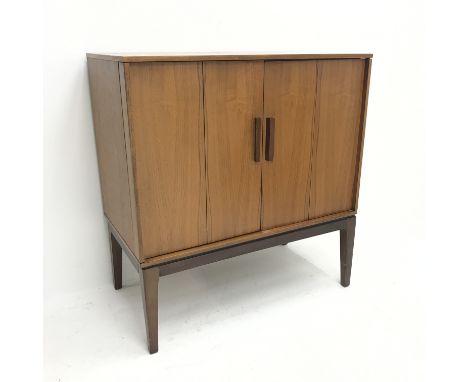 Mid century teak cabinet, two bi-fold doors enclosing single shelf on stand, W78cm, H83cm, D42cm Condition Report Click here 