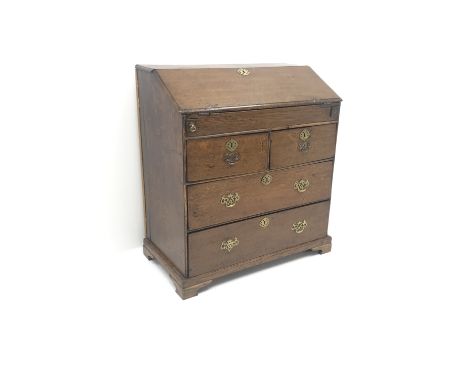 George III oak bureau, fall front enclosing fitted interior with well, two short and two long drawers, shaped bracket support
