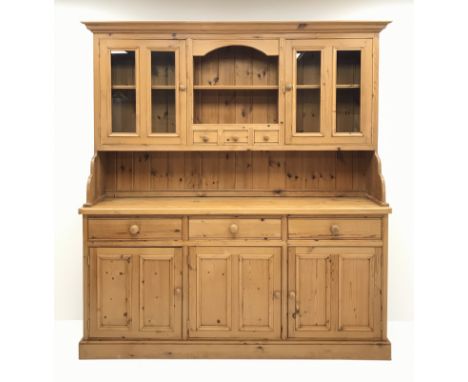 Traditional waxed pine dresser, top section fitted with two glazed display cabinets, shelf and spice drawers, lower section w