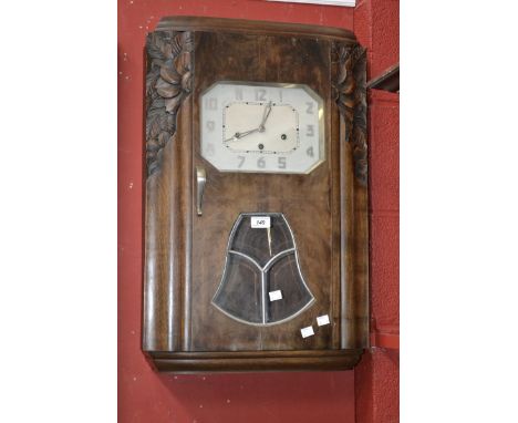 An Art Deco wall clock, silver lozenge shaped dial, serpentine angles,carved in relief. 