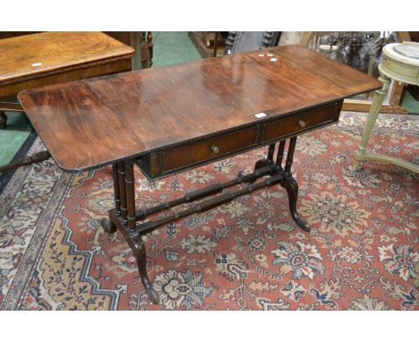 A 19th century mahogany rounded rectangular sofa table, reeded top above a pair of cockbeaded frieze drawers, tri-columnar en