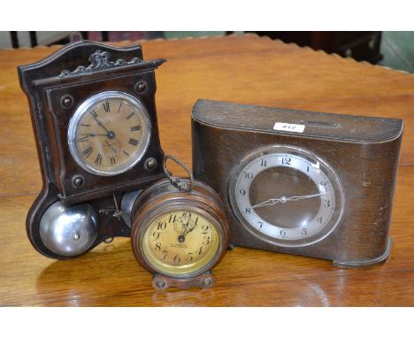 An early 20th century German alarm wall clock, striking on two bells, made in Wurtemberg; a turned mahogany circular alarm cl