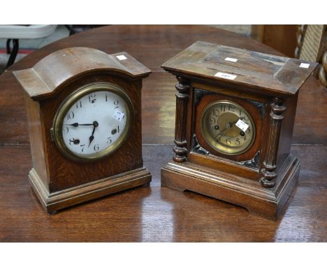 An early 20th century oak mantel clock; another similar (2)