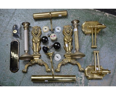 A pair of brass andiron ends, picture lights, candlesticks, ceramic door furniture etc.