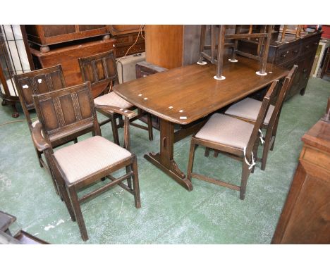 An Ercol refectory style table; four dining chairs and two carvers (7)