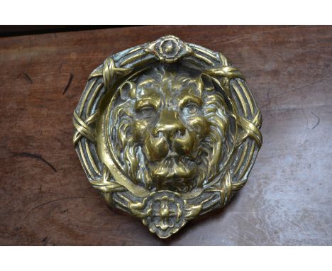 A large brass lion mask door knocker, 23cm diameter.