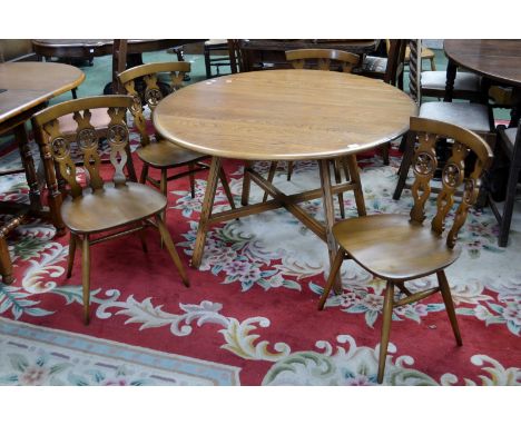 An Ercol golden dawn dropleaf dining table and four chairs.