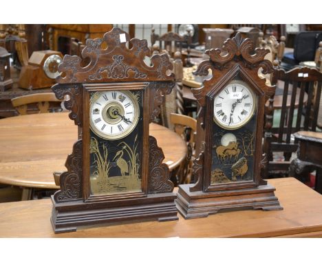 An American eight day mantel clock, the door printed in gilt with a stork, Forestville USA paper label to verso; another simi