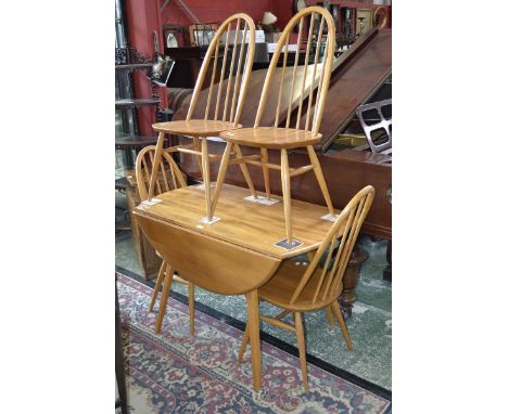 A light Ercol style dropleaf table and four spindle back dining chairs. (5)