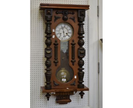A 19th century style Vienna wall clock, carved arched pediment, white enamel dial, twin winding holes, Roman numerals, pendul
