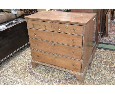 A Queen Anne/George I oak chest of two short and three long graduated drawers, brass drop handles, bracket feet, 93cm high, 9