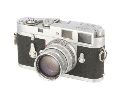 A Leica M2 Rangefinder Camera, 1960, chrome, serial no. 994340, with Leitz Summicron f/2 50mm Rigid lens, 1957, chrome, seria