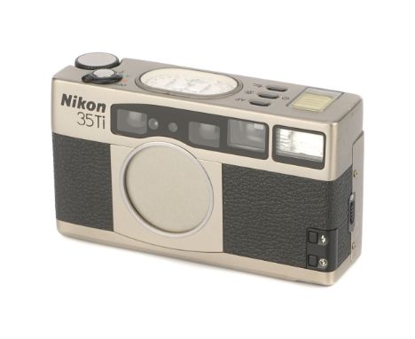 A Nikon 35Ti Compact Camera, 1993, titanium, serial no. 5035520, with Nikon f/2.8 35mm lens, body, VG, shutter not tested, le