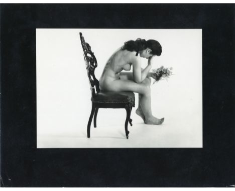 LARRY COLWELL (1911-1972) Nude Study, a vintage gelatin silver print of seated nude with flowers, c.1960, printed with black 