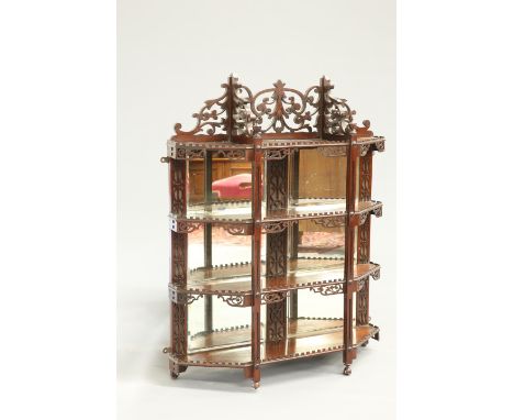 A SET OF MAHOGANY MIRROR-BACK HANGING SHELVES, IN CHIPPENDALE STYLE, 19TH CENTURY, with fret carved pediment above four shelv