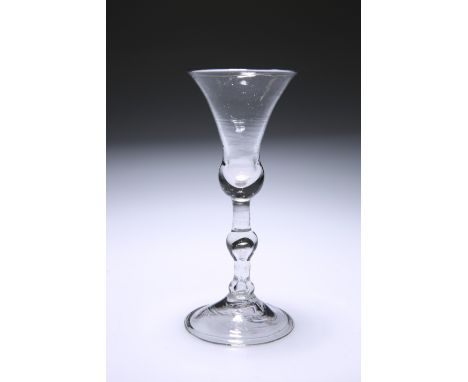 A LIGHT BALUSTER WINE GLASS, CIRCA 1730, with bell bowl on a knopped tear-drop stem, raised on a domed folded foot.&nbsp;16.3