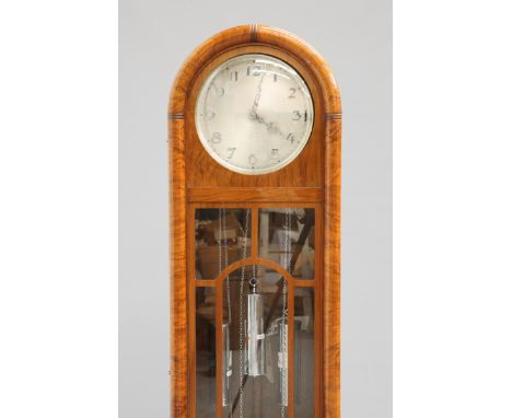 A GERMAN ART DECO WALNUT LONGCASE CLOCK, the case with arch-top and long glazed door, three-weight driven movement with chime