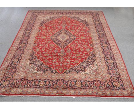 A LARGE PERSIAN HAND-KNOTTED CARPET. 342cm by 245cm