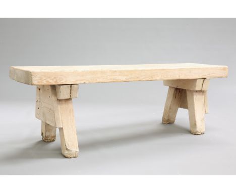 A 19TH CENTURY OAK PIG BENCH, the substantial top raised on splayed block legs. 134cm long